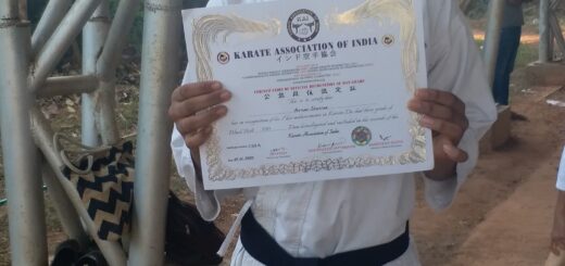 Arnav with his black belt certificate from JKA