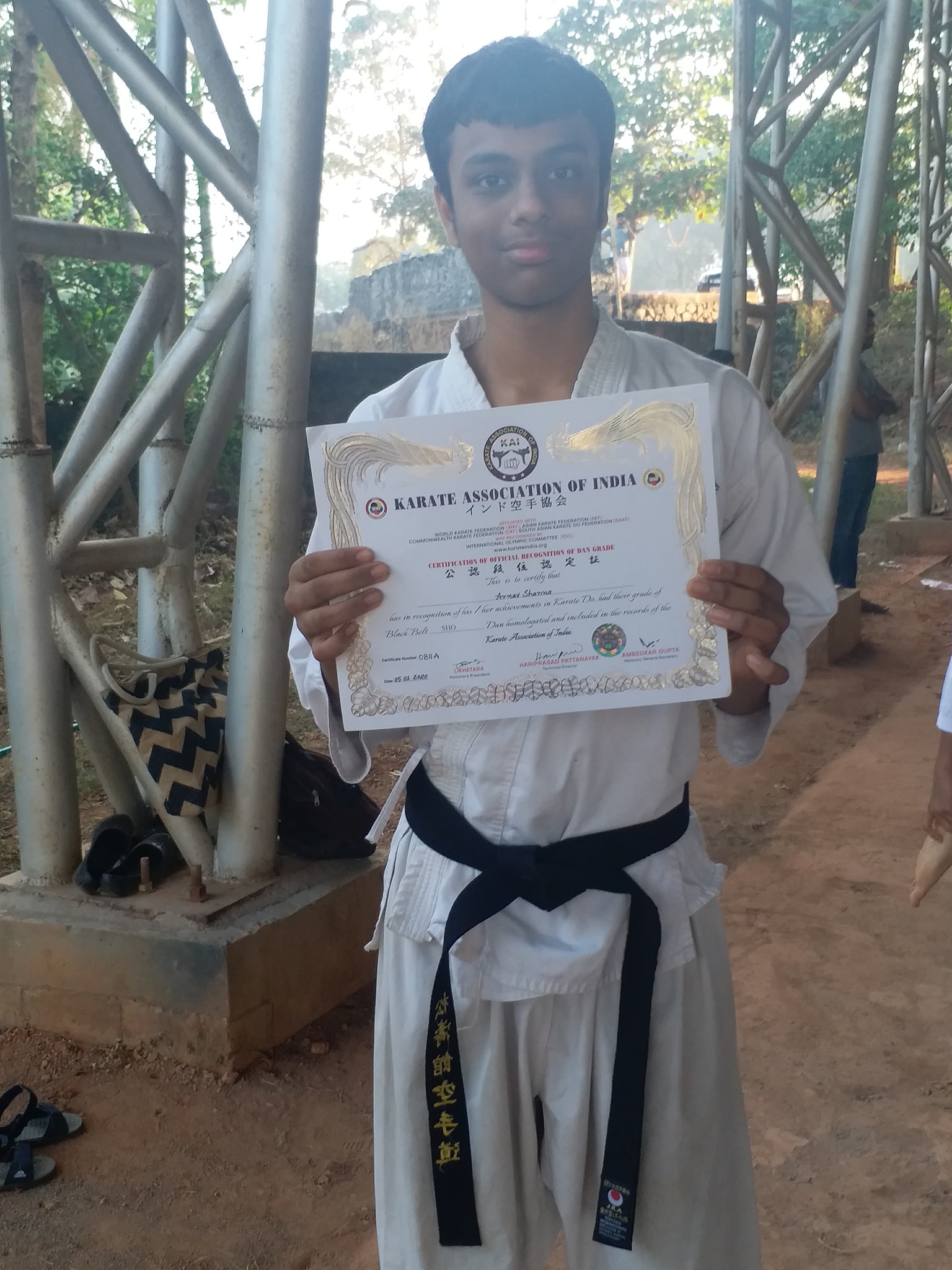 Arnav with his black belt certificate from JKA